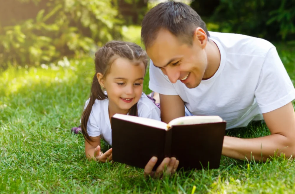 Father reading to daughter