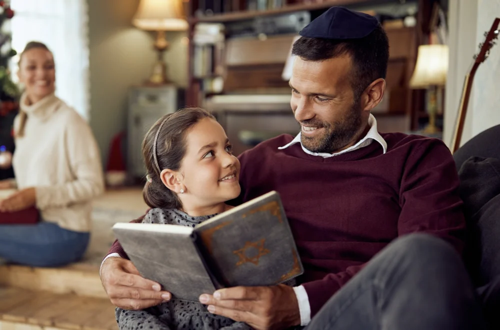 Father reading to daughter