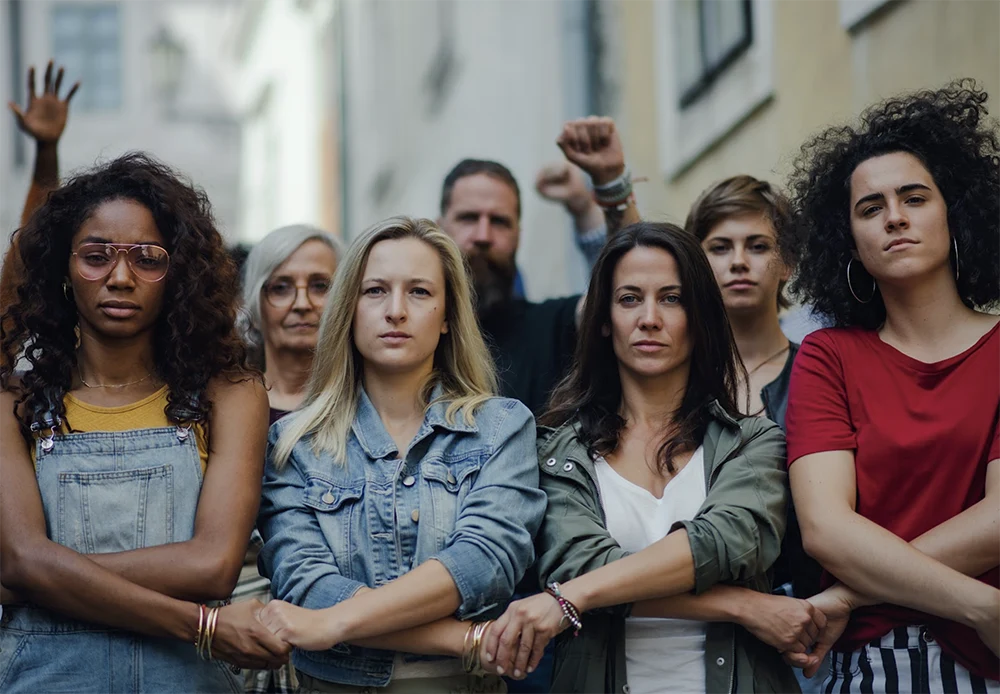 Women at protest standing holding hands