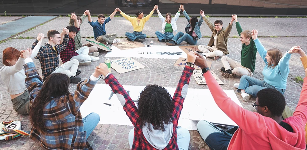 Women sitting in a circle with raised hands