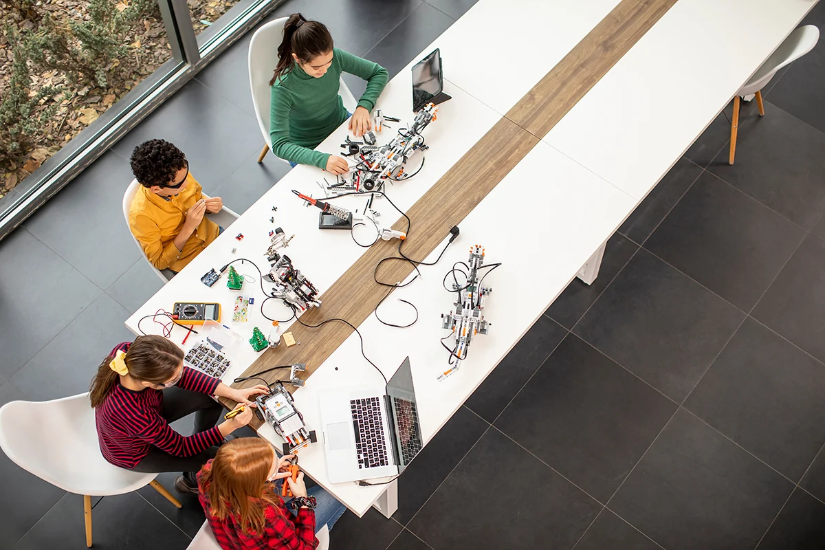 High angle image of students working with technology