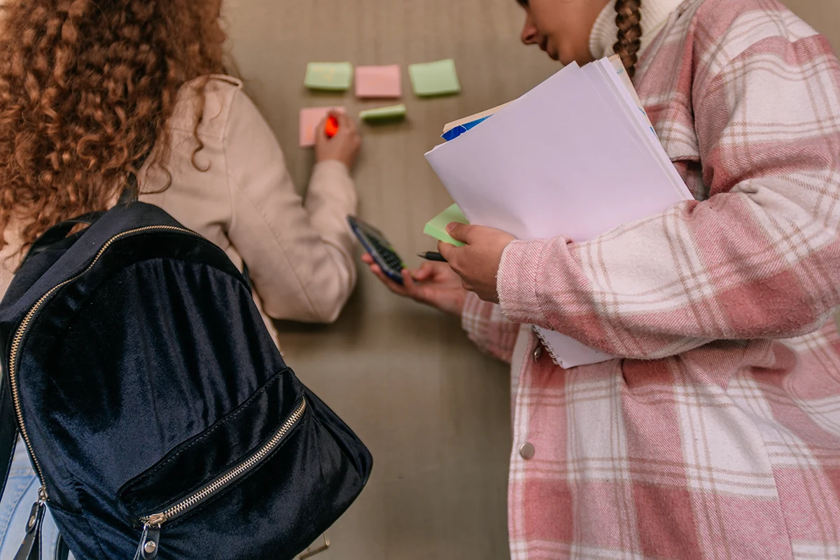 Students using post-it notes and calculators