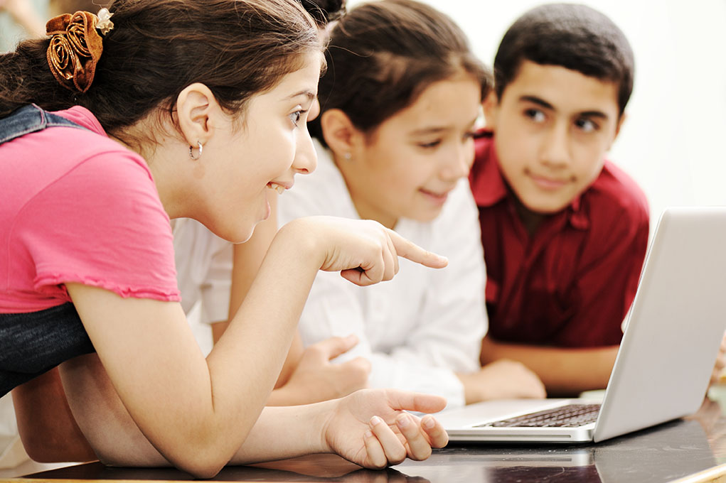 Children pointing at computer